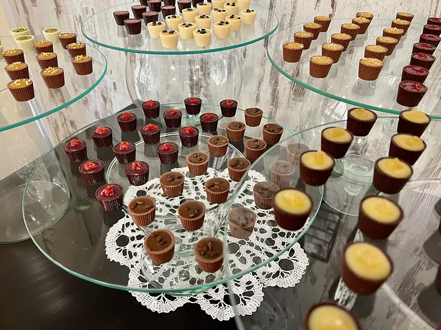 Tiered glass stands with several kinds of filled chocolate cups