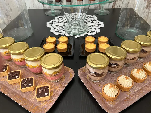 Desserts in jars and mini tarts on trays