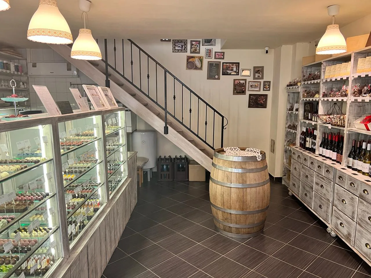The showroom interior with the bonbon counter, the stairs to the gallery and an oak barrel